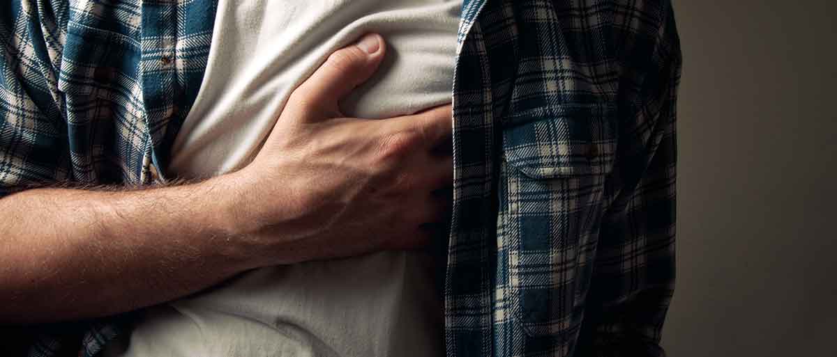 Man experiencing chest pain after alcohol consumption
