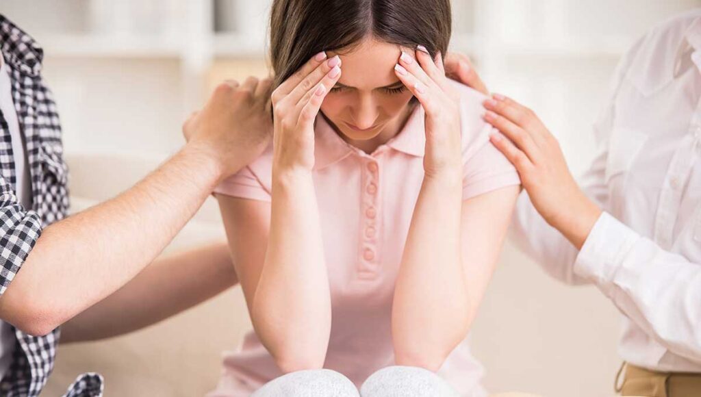 a woman holding her head