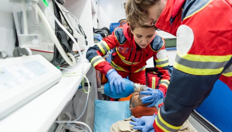 Paramedics in latex gloves doing cardiopulmonary resuscitation